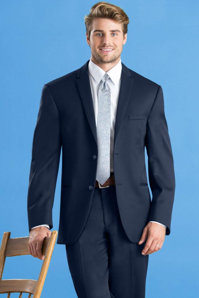 man in a Michael Kors navy blue suit and silver windsor tie